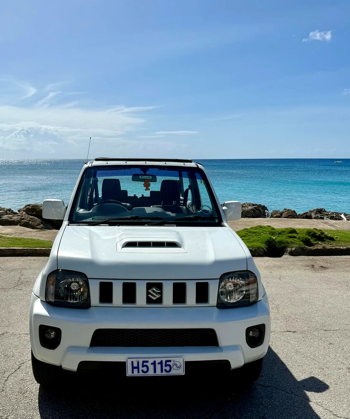 Suzuki Jimny rental in Barbados facing the camera on the waterfront