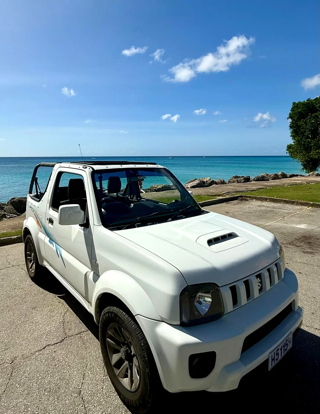 Suzuki Jimny rental in Barbados at a three-quarter angle on the waterfront